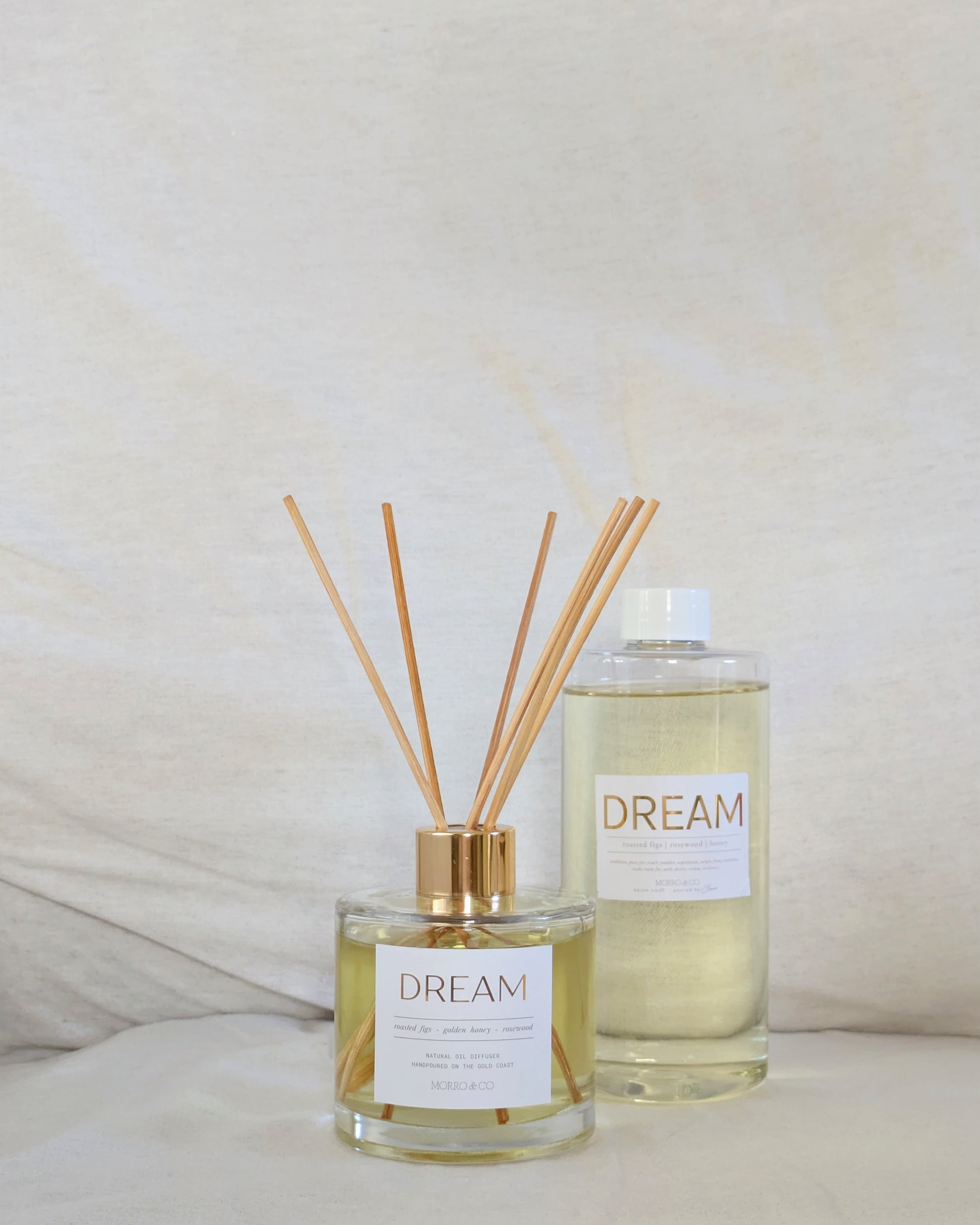 Two eco natural diffusers labeled 'Dream' on a neutral background