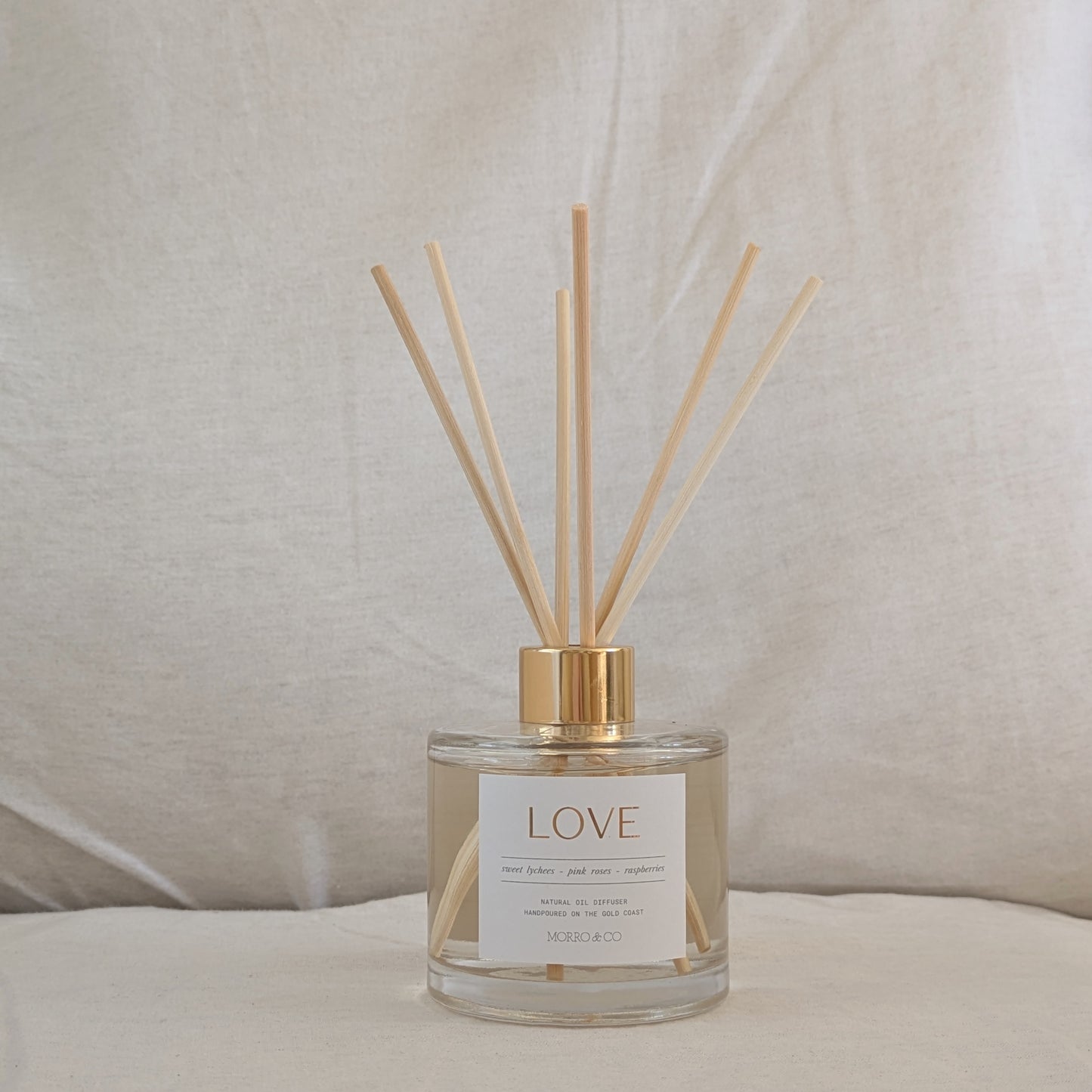 Reed diffuser labeled 'LOVE' on a neutral background