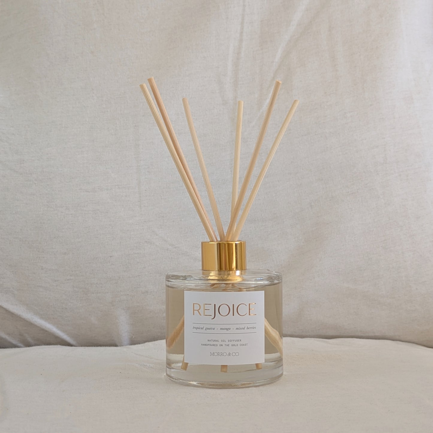 Rejoice eco reed diffuser with wooden sticks on a neutral background