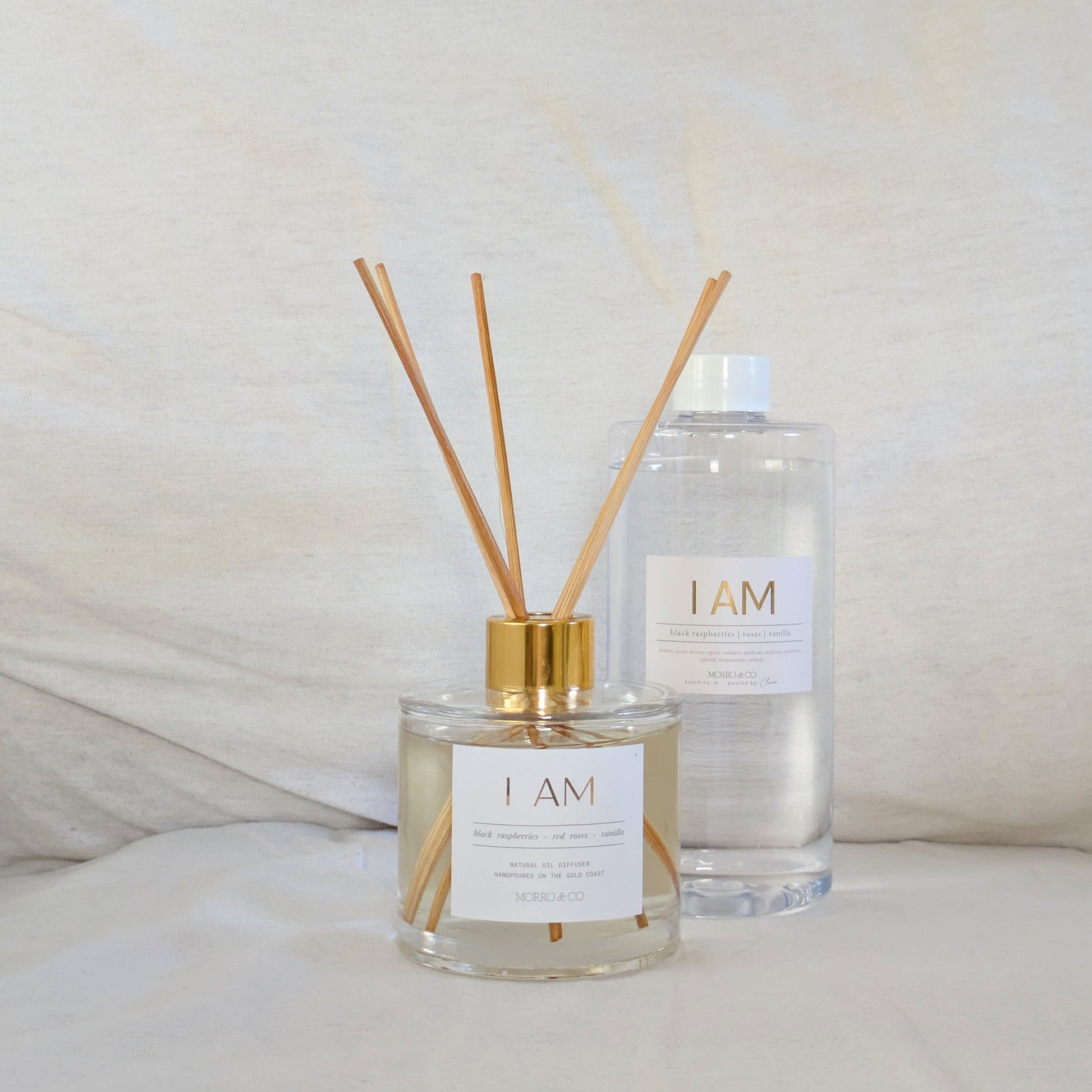 Two diffusers labeled 'I AM' on a light background
