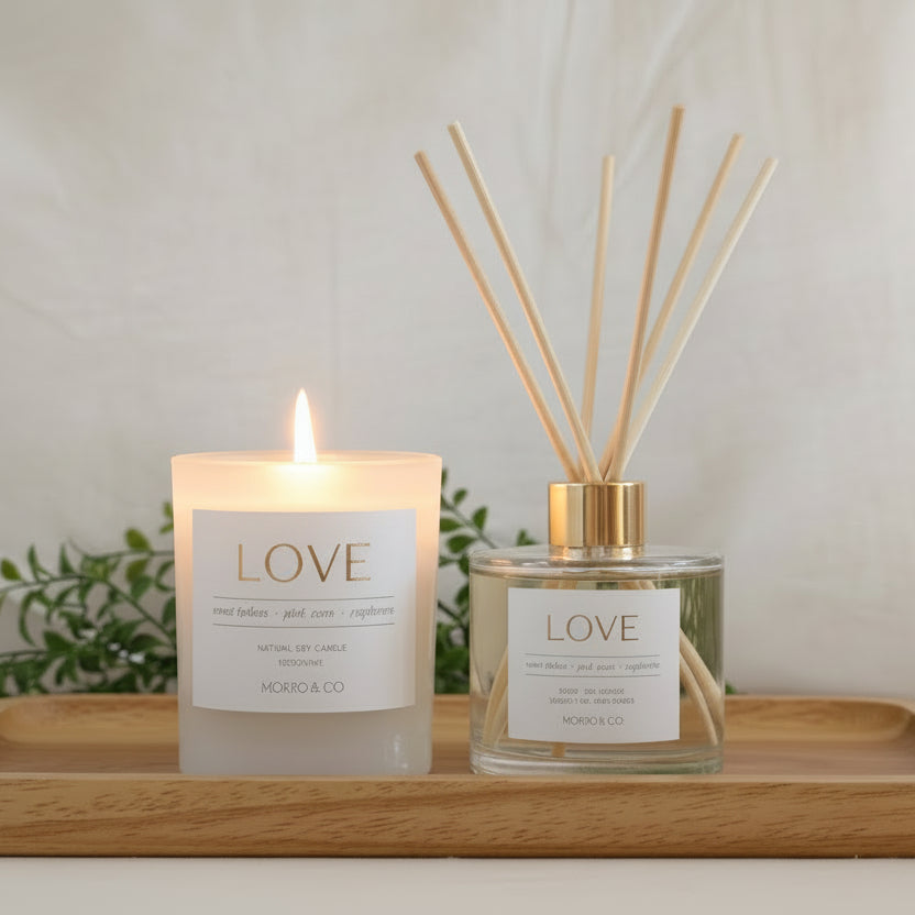 Two scented products, a candle and a diffuser, with 'LOVE' label on a neutral background.