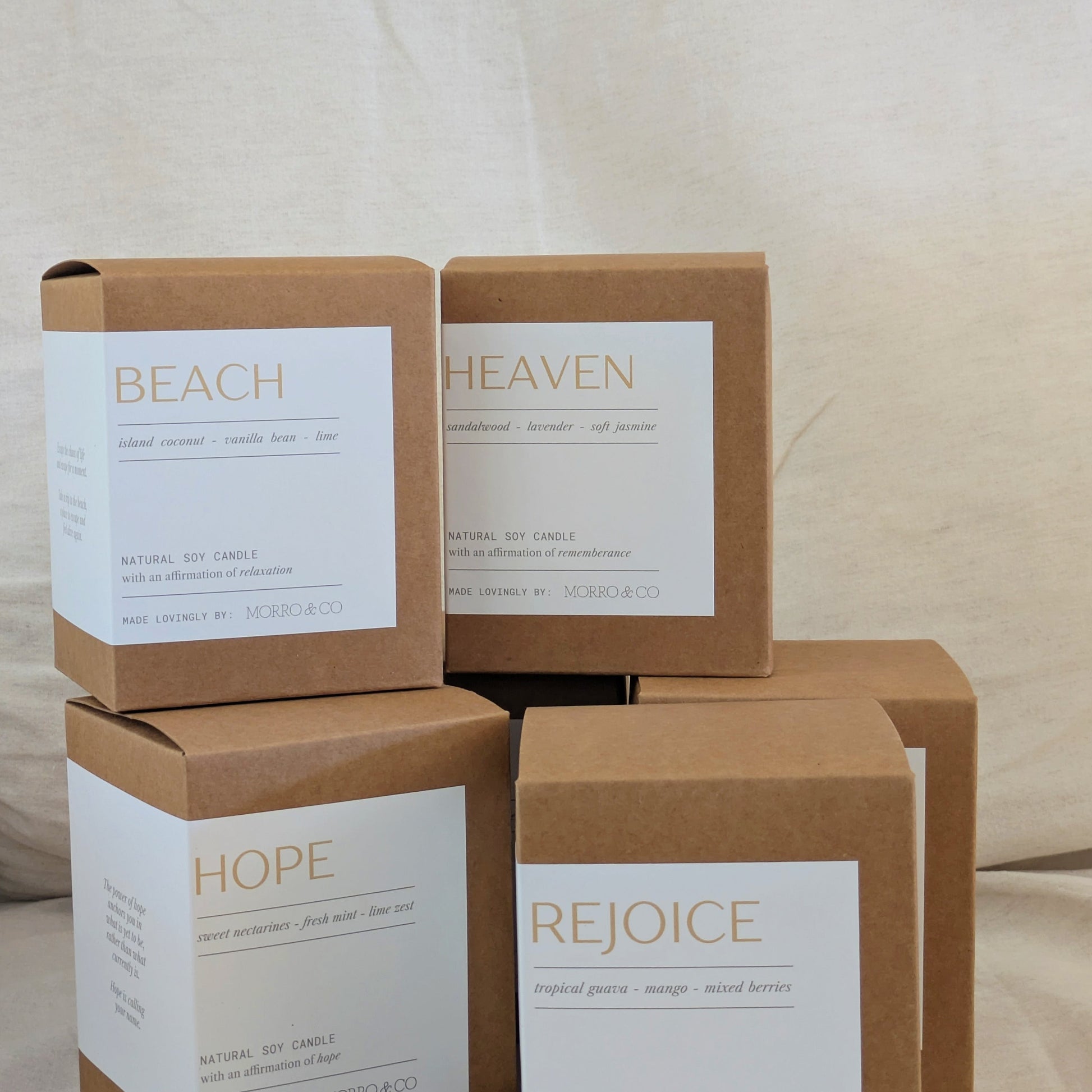 Stack of brown cardboard boxes with 'Beach', 'Heaven', 'Hope', and 'Rejoice' labels on a neutral background.