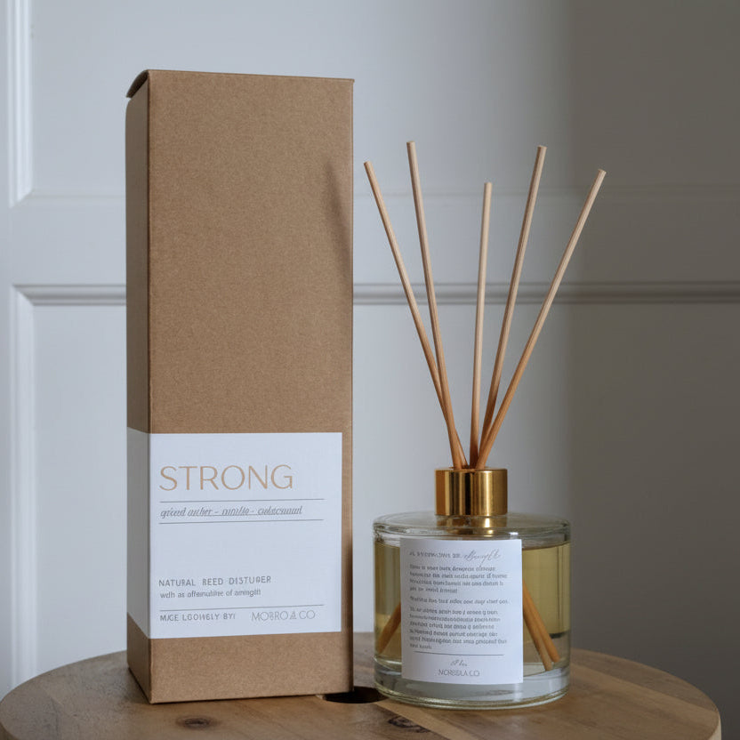 Candle and packaging labeled 'STRONG' on a wooden surface.