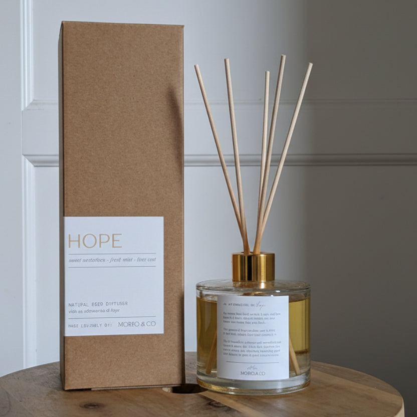 Diffuser and packaging labeled 'HOPE' on a wooden surface.