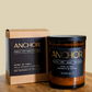 Anchor candle and packaging on a wooden surface with a beige background