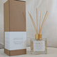 Natural eco reed diffuser with 'Beach' label and brown packaging box on a neutral background