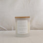 Back of DREAM candle with a wooden lid and affirmation label on a white background