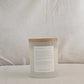 Back of NEW DAY candle with an affirmation label on a white background