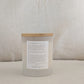 STRONG candle with affirmation label on a beige cushion