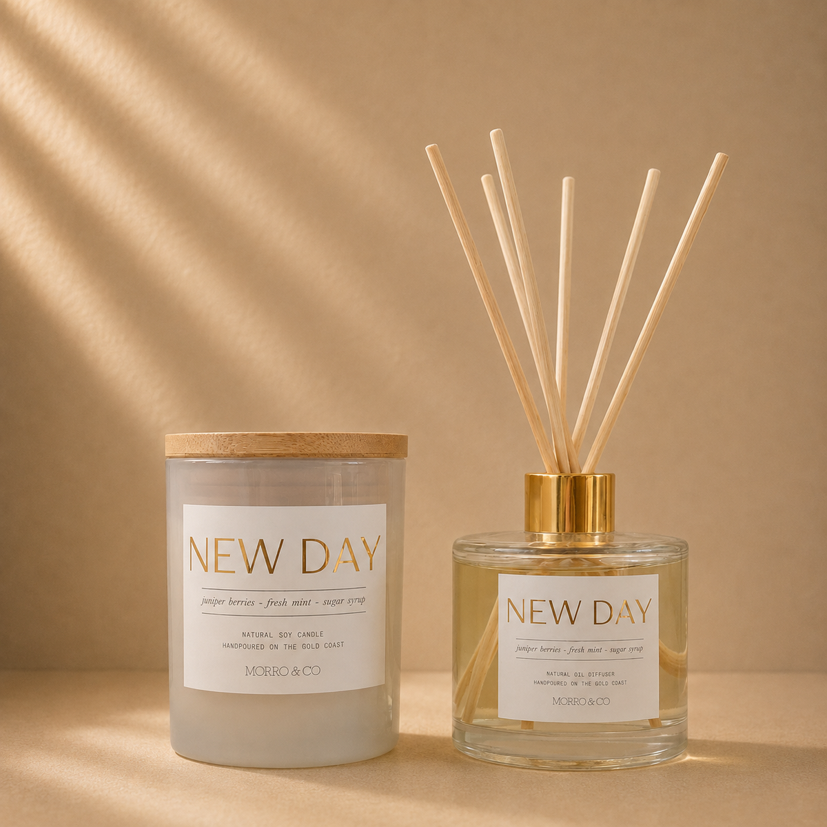 Morro & Co NEW DAY natural soy candle and eco reed diffuser on a warm beige background