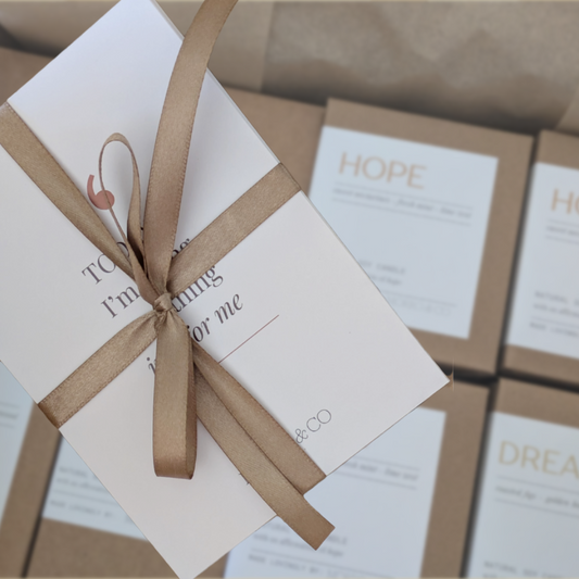Gift box with a bow with affirmation card set on a blurred background