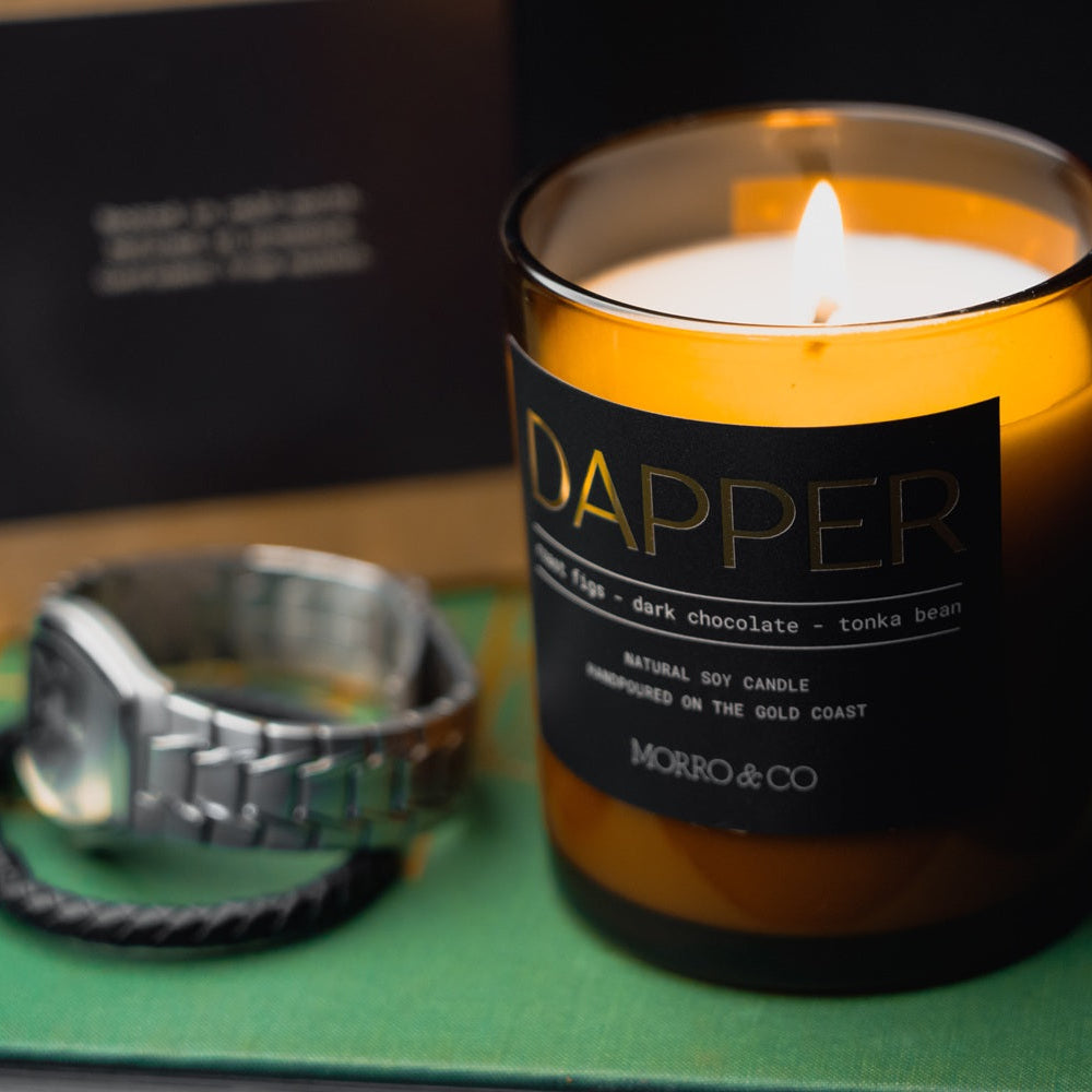 Morro & Co masculine candle labeled 'Dapper' with a watch on a green surrounds.