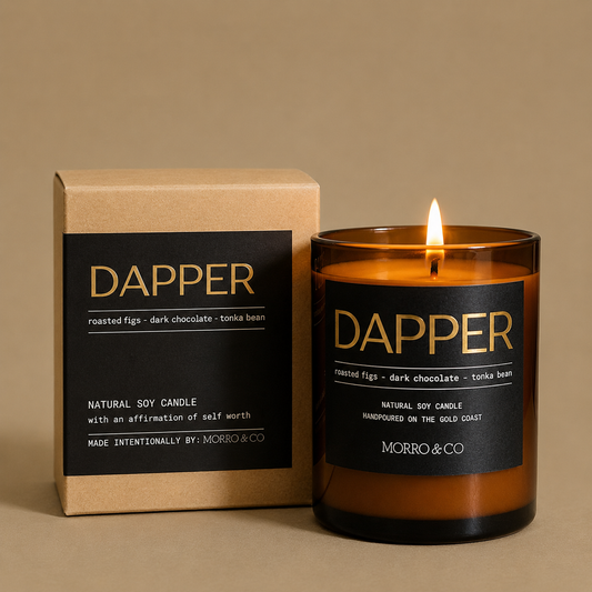 Dapper candle with packaging on a beige background