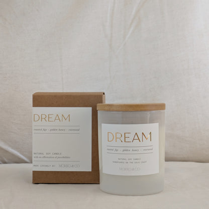 Candle labeled 'Dream' with a matching box on a neutral background