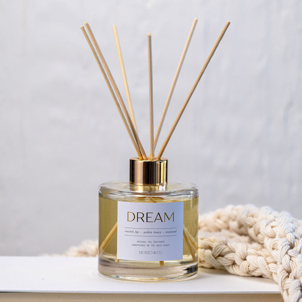 Diffuser with 'Dream' label on a light surface with a neutral background