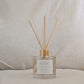 Reed diffuser labeled 'LOVE' on a neutral background