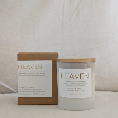 Candle labeled 'Heaven' with a wooden lid and packaging on a neutral background