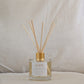 Natural eco reed diffuser labeled 'HOPE' with wooden sticks on a neutral background