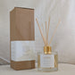 Natural eco reed diffuser bottle labeled 'Hope' with reeds and a matching box on a neutral background