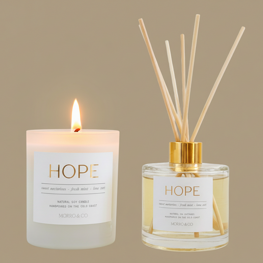 Candle and diffuser set with 'HOPE' label on a beige background