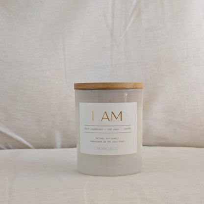 Candle with a wooden lid and white label on a beige background