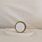 Gold candle travel tin labelled 'LOVE' on a white surface with a neutral background