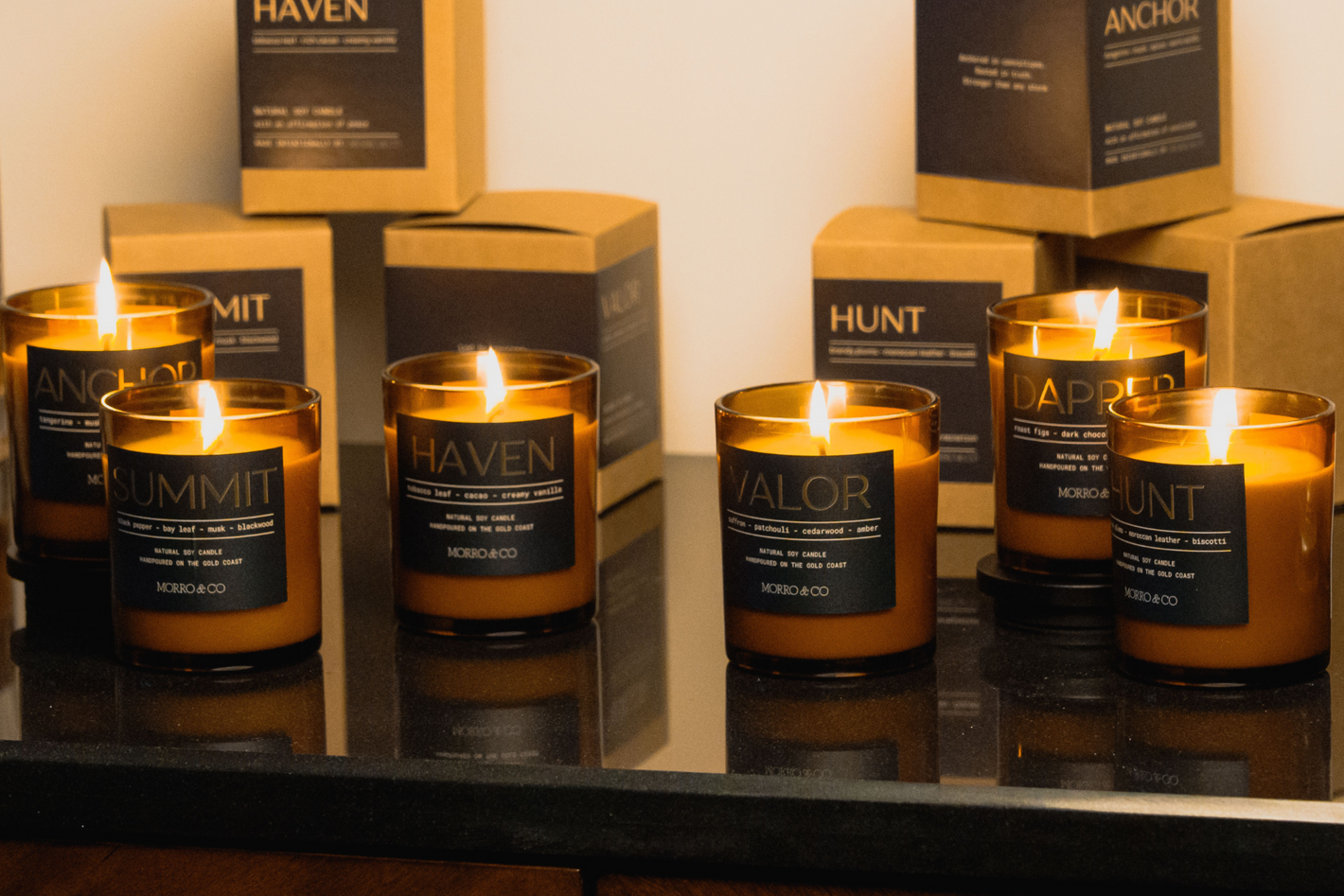Collection of candles and decorative items on a shelf with 'Haven' and 'Anchor' branding.