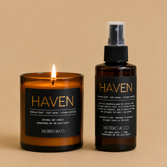A MORRO&CO brand 'HAVEN' scented candle in an amber glass jar next to a matching amber glass room spray bottle, both with black labels and gold lettering, set against a solid beige background.