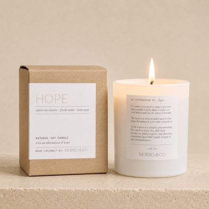Candle with a box labeled 'Hope' by Morro & Co on a beige background