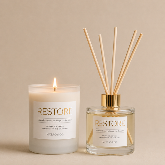Morro & Co 'RESTORE' products, a candle and a diffuser, on a beige background.