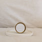 Gold candle travel tin labeled 'NEW DAY' on a white surface