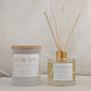 Two 'New Day' products, a candle and a diffuser, on a neutral background.