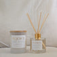 Two 'REJOICE' products, a candle and a diffuser, on a neutral background.