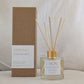 Eco reed diffuser with 'STRONG' branding next to its packaging on a neutral background