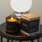 Morro & Co masculine candle labelled 'Summit' and packaging on a table with a spherical lamp in the background