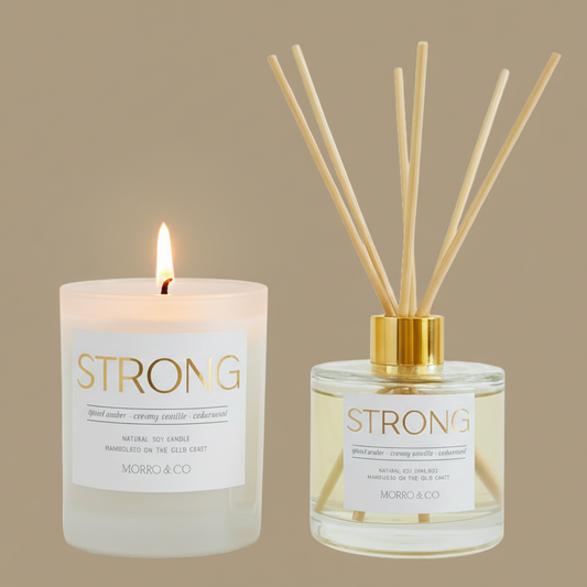 Candle and diffuser set with 'STRONG' branding on a beige background