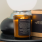 Candle with a label on a surface, with a blurred background