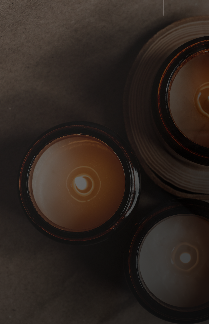 Three candles on a textured surface with 'integrity care courage' text.