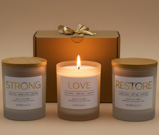 Three candles labeled 'Strong', 'Love', and 'Restore' with a gift box in the background.