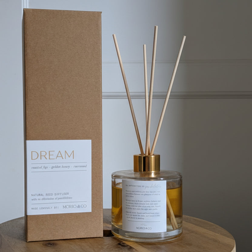 Diffuser and packaging labeled 'Dream' on a wooden surface.