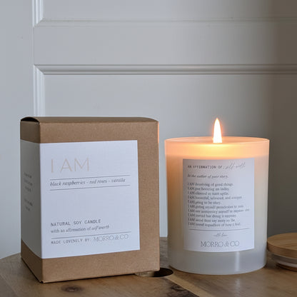 Candle and packaging on a wooden surface with a neutral background