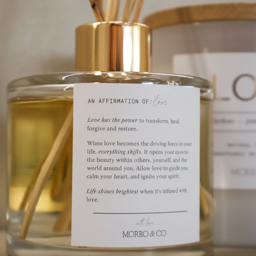 Gold bottle with a label on a neutral background