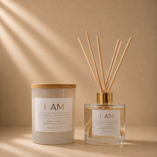 Morro & Co I AM natural soy candle and eco reed diffuser on a warm beige background