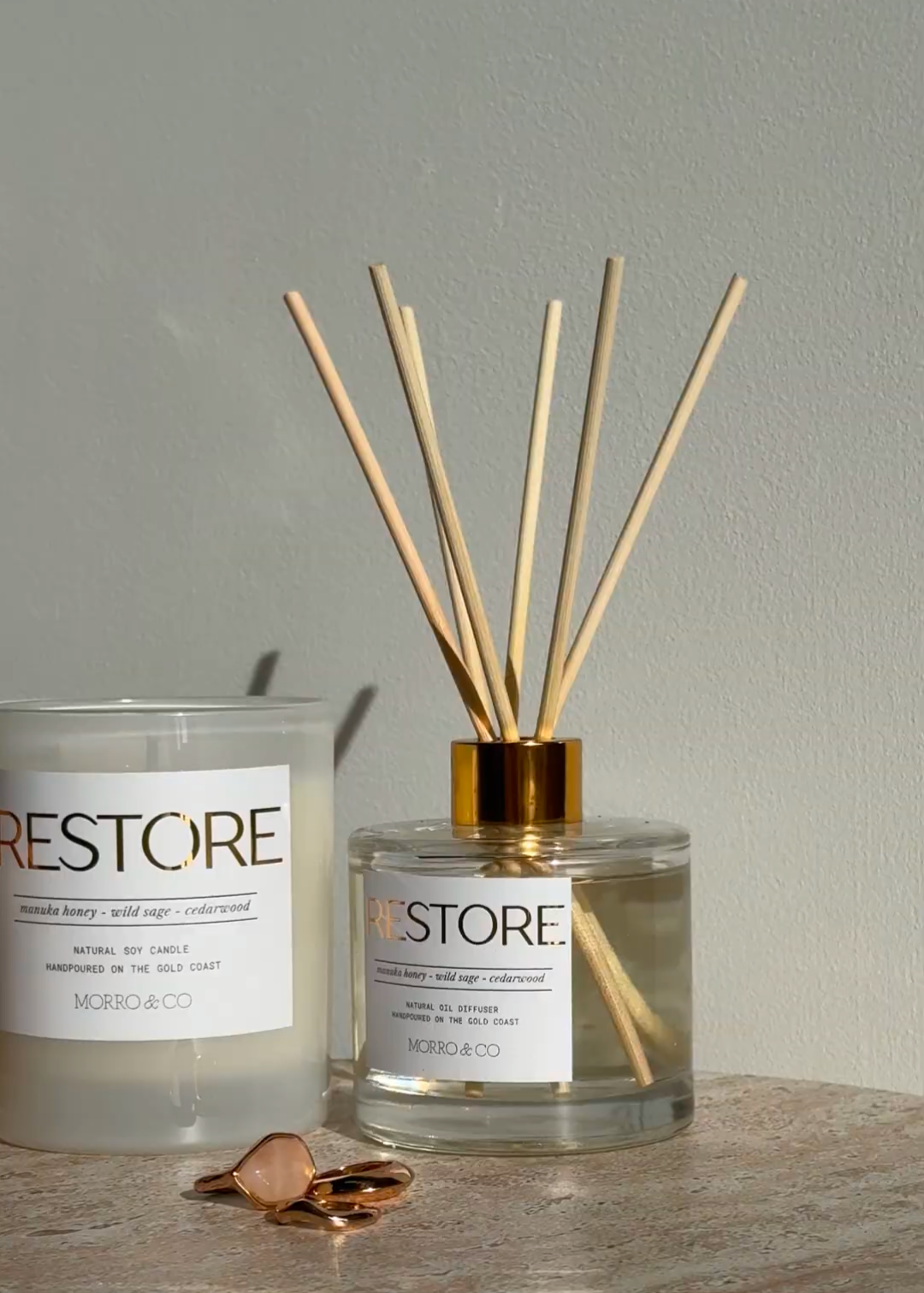 Two 'RESTORE' products on a stone surface with a neutral background